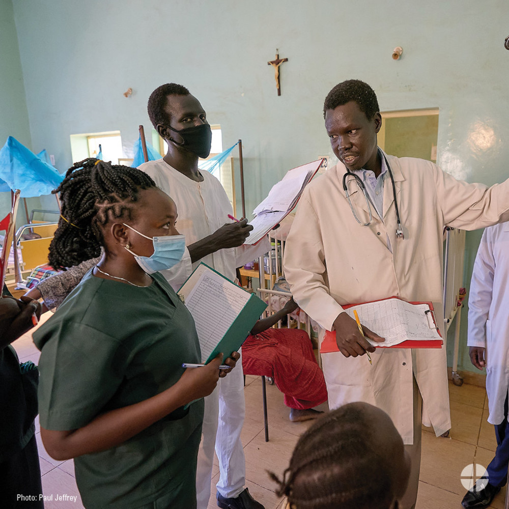 photo of physician and nurses in an African Catholic Hospital helping patients