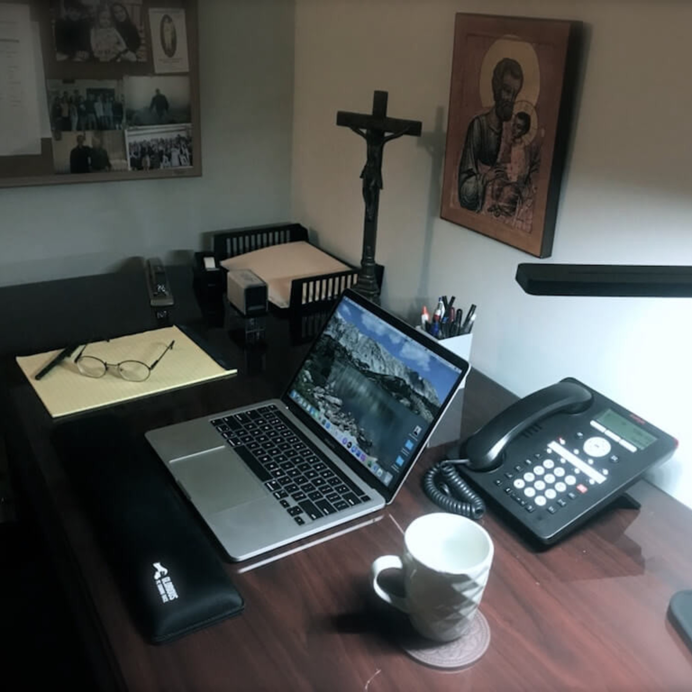 desk with computer telephone and desk ligh
