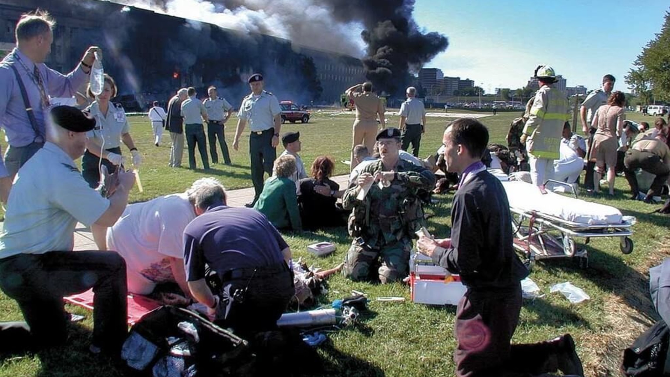 Fr. Steven McGraw prays with victims outsdide the Pentagon on 9/11/2001