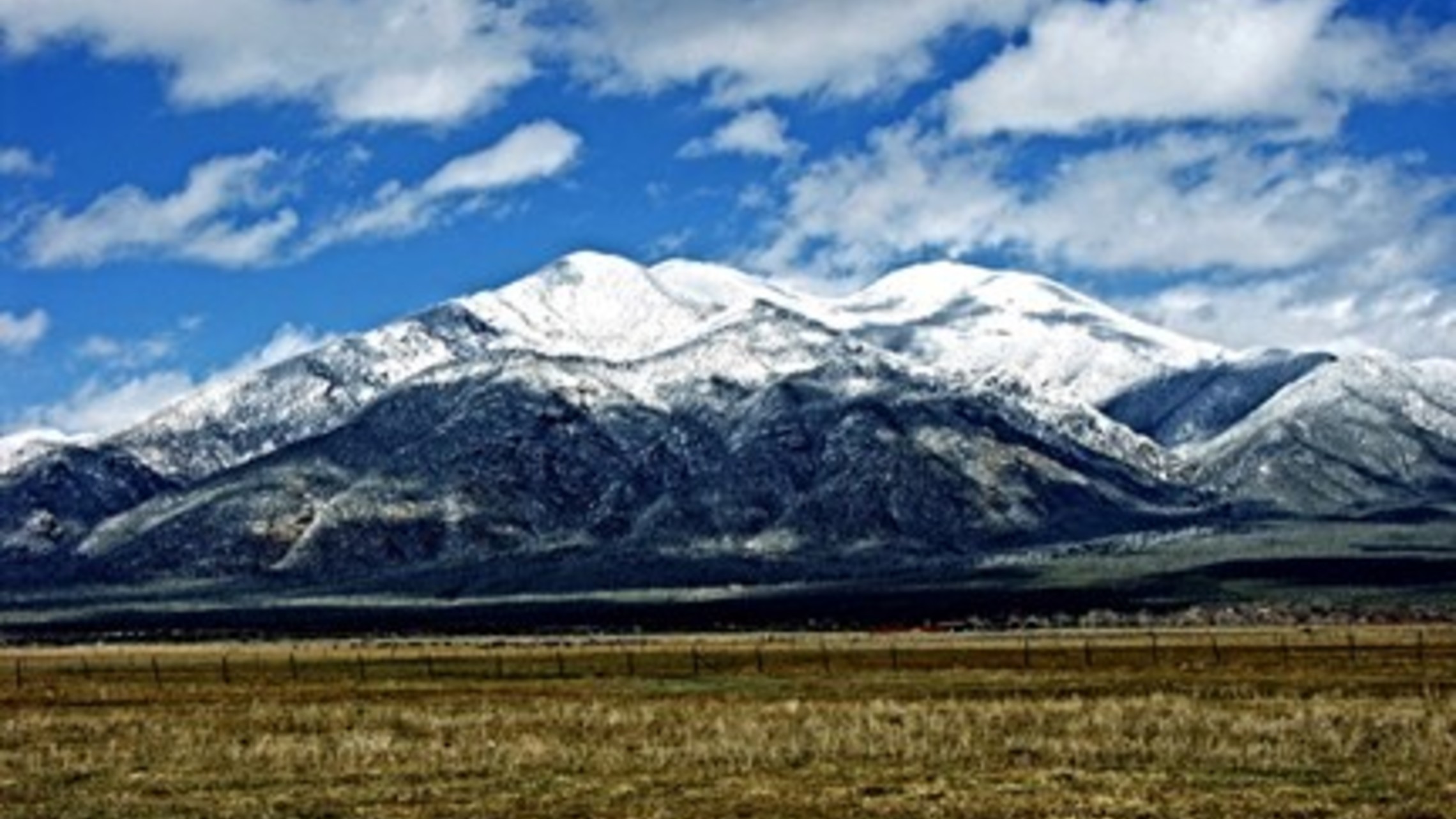 landscape of plains  and snow capped mountains
