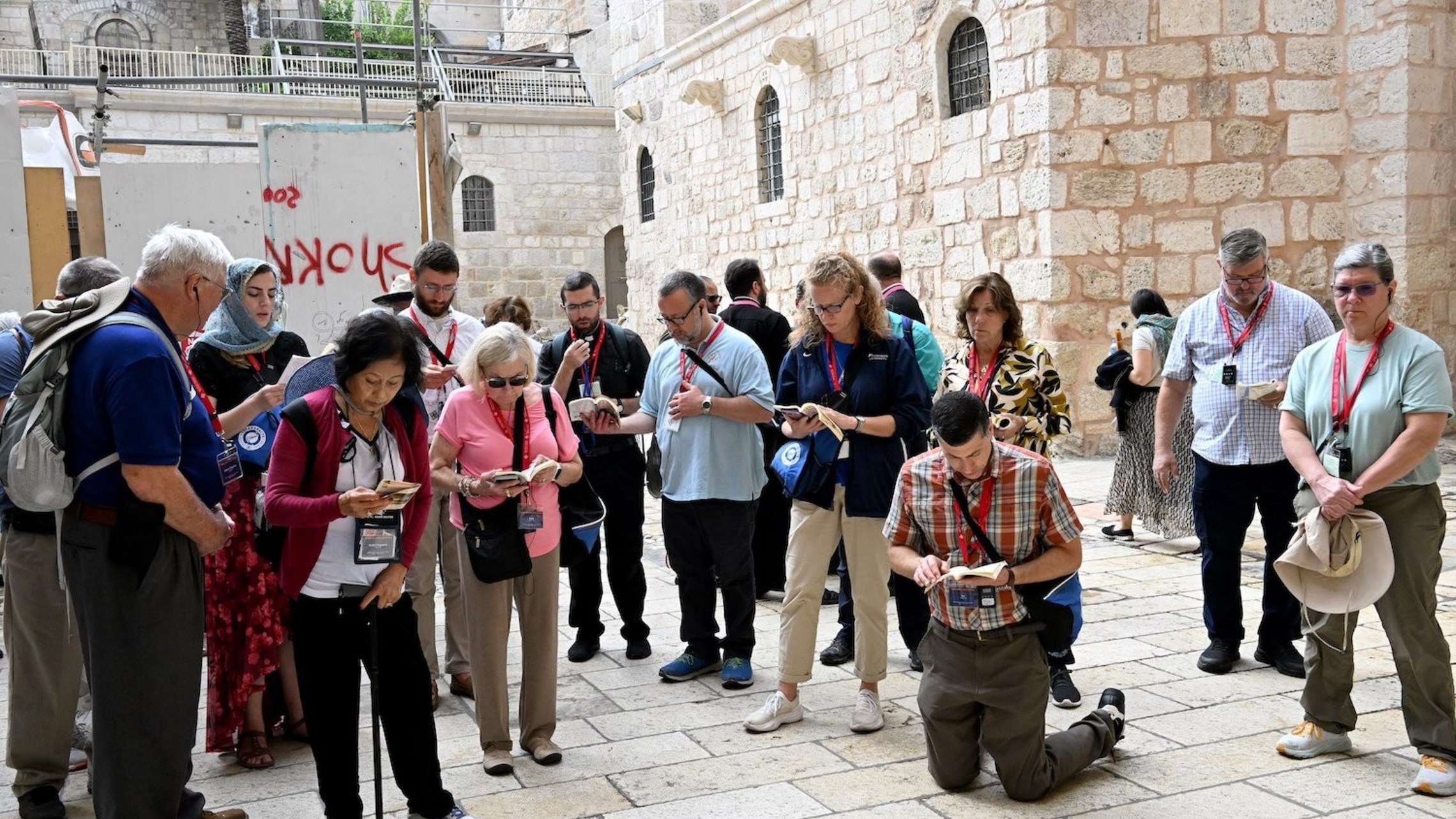 Pilgrims from the Diocese of Arlington, Va., pray in the courtyard of the Church of the Holy Sepulcher.