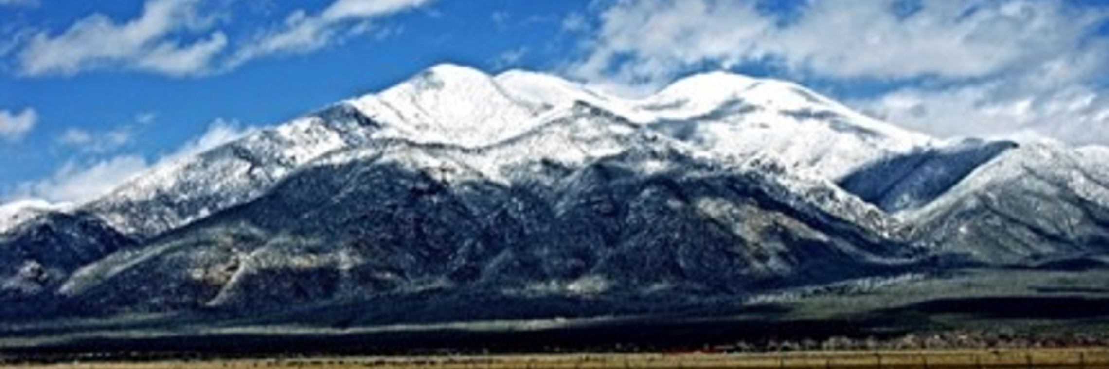 landscape of plains  and snow capped mountains